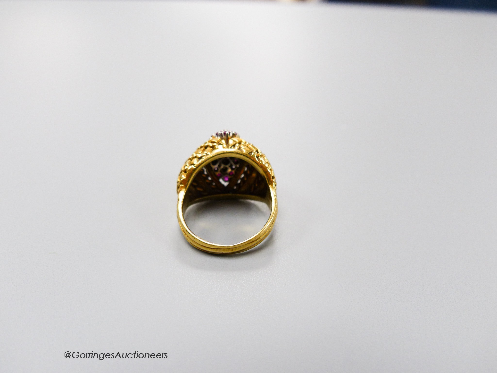 An early 1970's 14ct gold, ruby and diamond set dress ring, size L, gross 9.1 grams.